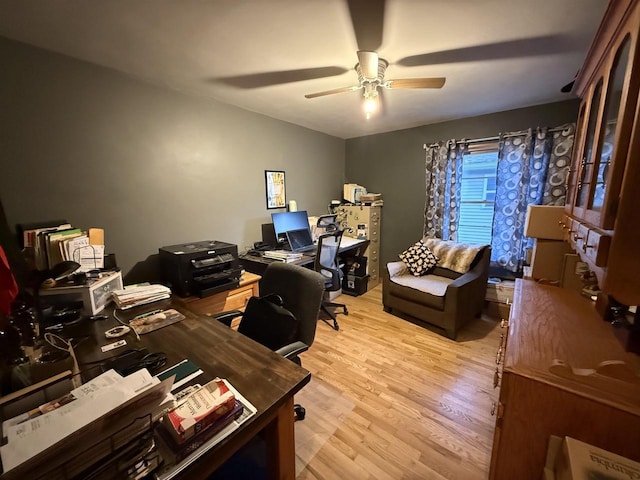 office area with light wood-style floors and a ceiling fan