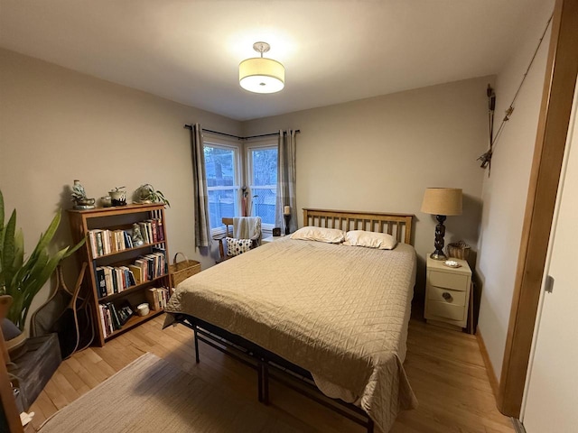 bedroom featuring light wood-style flooring and baseboards