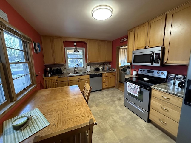 kitchen with backsplash, light brown cabinetry, stainless steel appliances, wood counters, and a sink