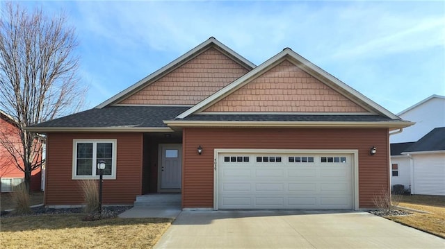 view of front of house featuring concrete driveway, an attached garage, and roof with shingles