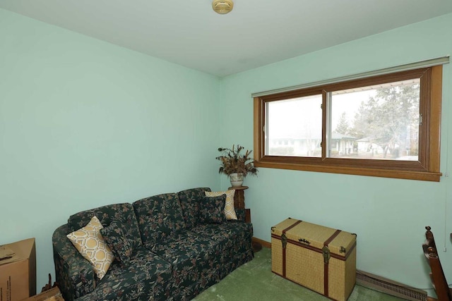 living area with a baseboard heating unit and carpet floors