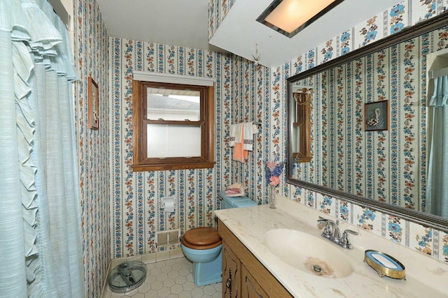 bathroom featuring tile patterned flooring, toilet, wallpapered walls, and vanity