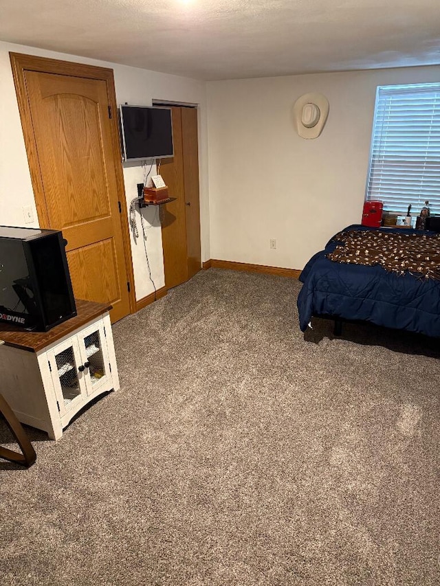 bedroom featuring carpet flooring and baseboards