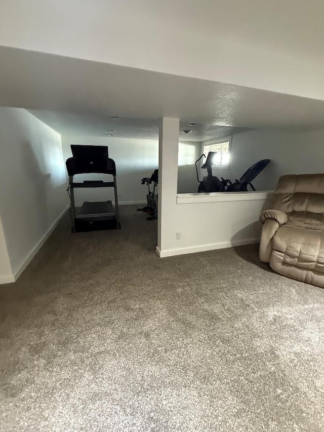 carpeted living room featuring baseboards