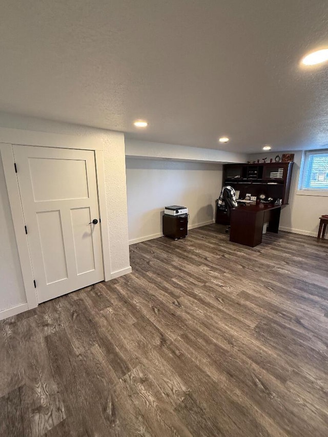 interior space with recessed lighting, a textured ceiling, dark wood-type flooring, and baseboards