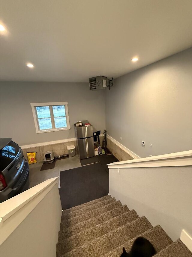 stairway featuring recessed lighting, carpet, and wainscoting