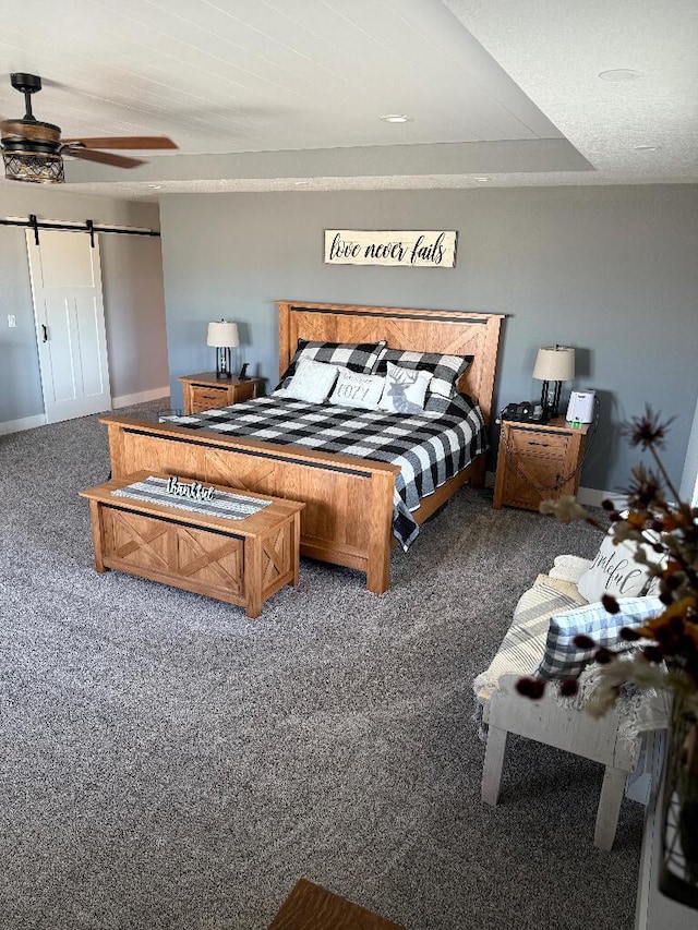 carpeted bedroom featuring a barn door