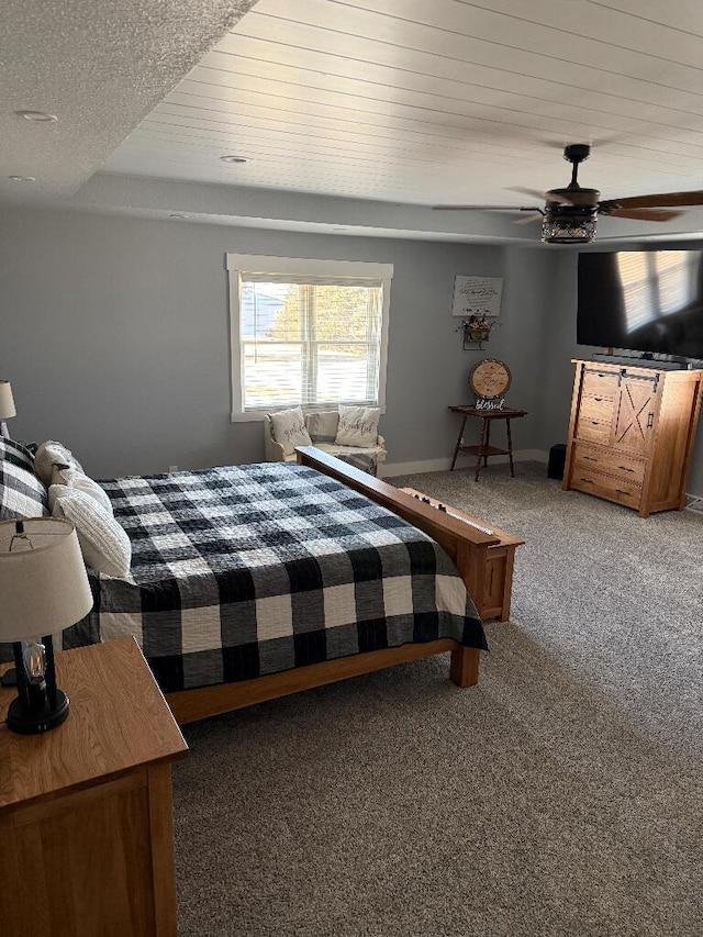 bedroom featuring light carpet, a ceiling fan, and baseboards