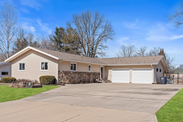 single story home featuring a front yard, concrete driveway, a garage, and roof with shingles