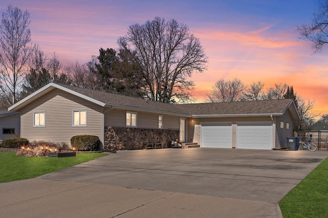 single story home featuring an attached garage, driveway, and a shingled roof