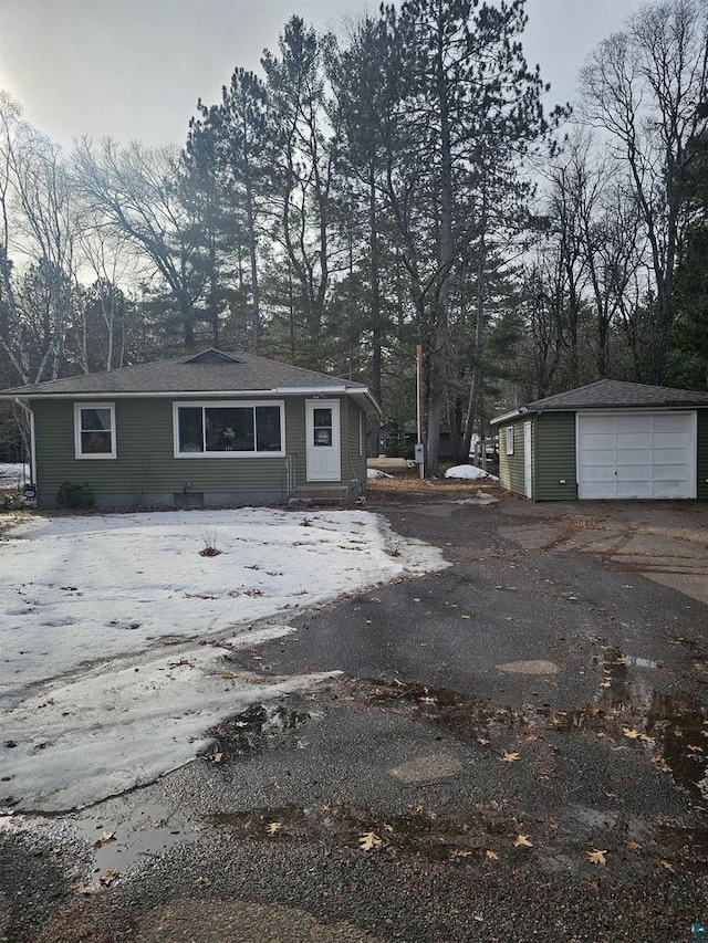 exterior space featuring a detached garage and an outdoor structure