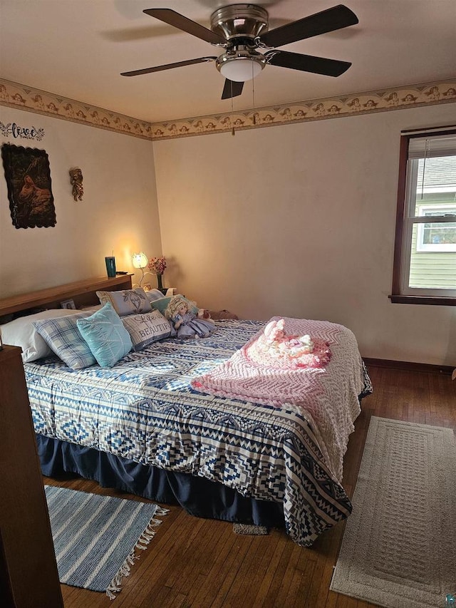 bedroom with wood-type flooring and ceiling fan