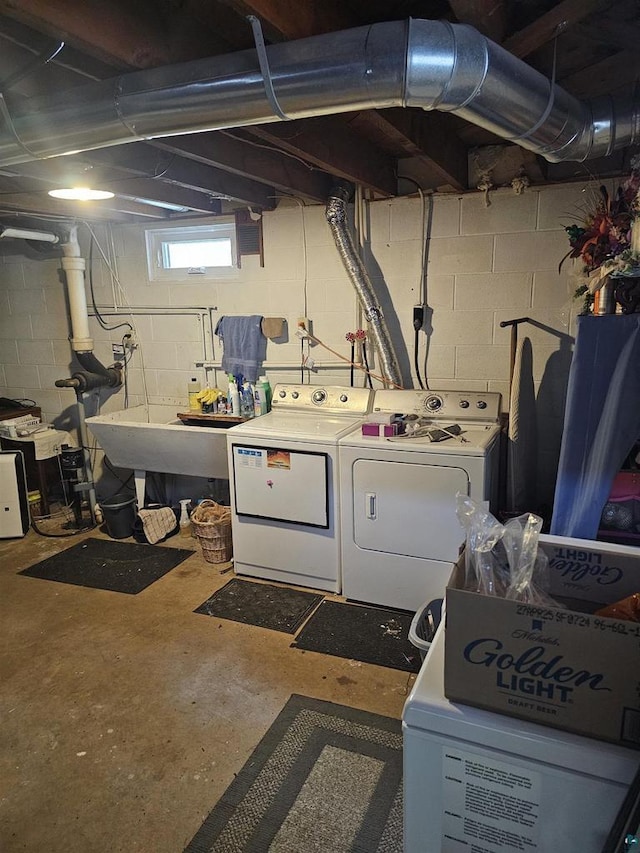 laundry room featuring laundry area, washing machine and dryer, and a sink