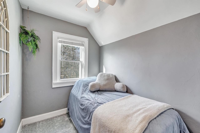 bedroom featuring vaulted ceiling, a ceiling fan, baseboards, and carpet floors