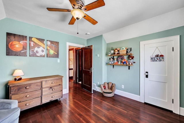 living area featuring a ceiling fan, visible vents, baseboards, and dark wood-style flooring