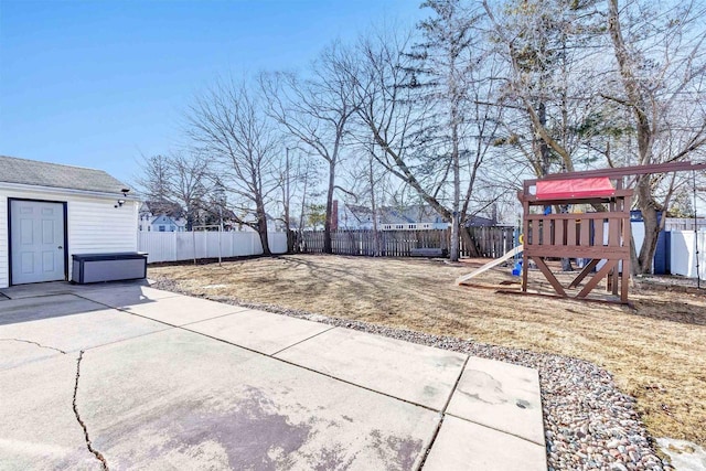 view of yard with a patio area, a playground, and a fenced backyard