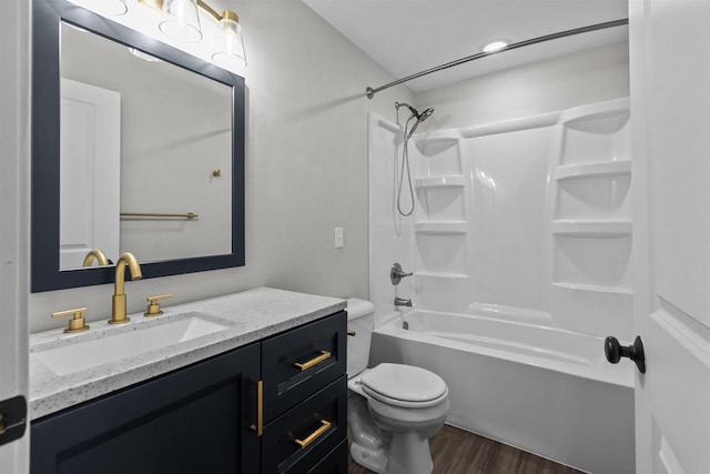 bathroom with toilet, vanity, bathtub / shower combination, and wood finished floors