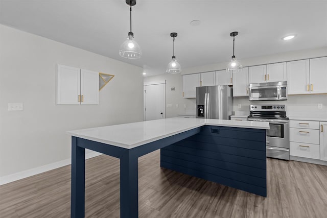 kitchen featuring white cabinets, appliances with stainless steel finishes, and light countertops