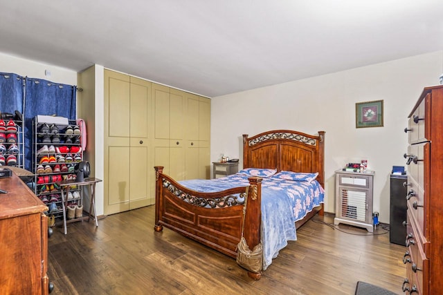 bedroom with dark wood-style flooring