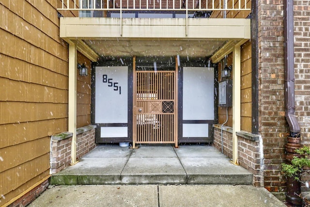 property entrance featuring brick siding