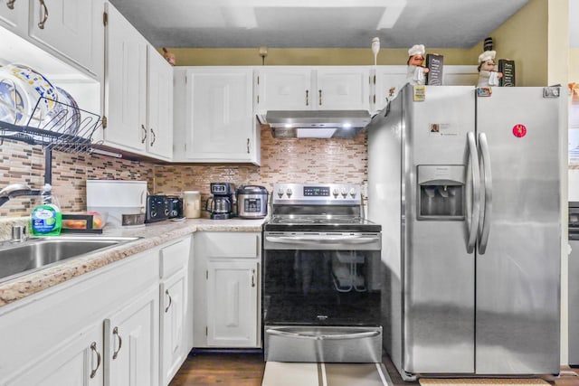 kitchen featuring decorative backsplash, white cabinetry, appliances with stainless steel finishes, and ventilation hood