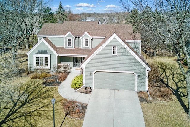 view of front of home with a porch, driveway, and a shingled roof