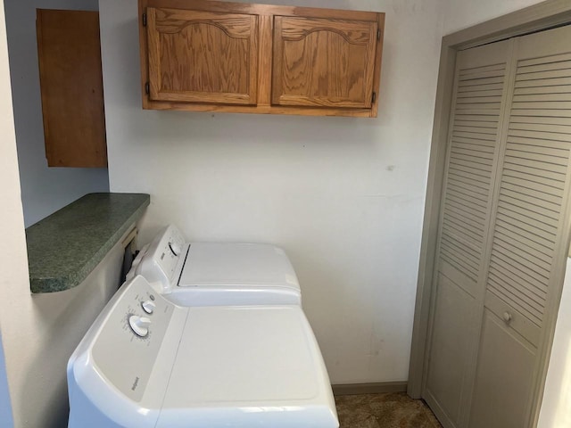 laundry room with cabinet space, separate washer and dryer, and baseboards