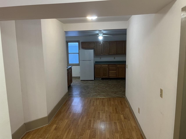 hall featuring dark wood finished floors and baseboards