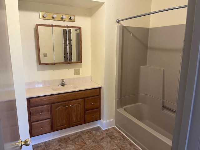 bathroom with baseboards, shower / tub combination, and vanity