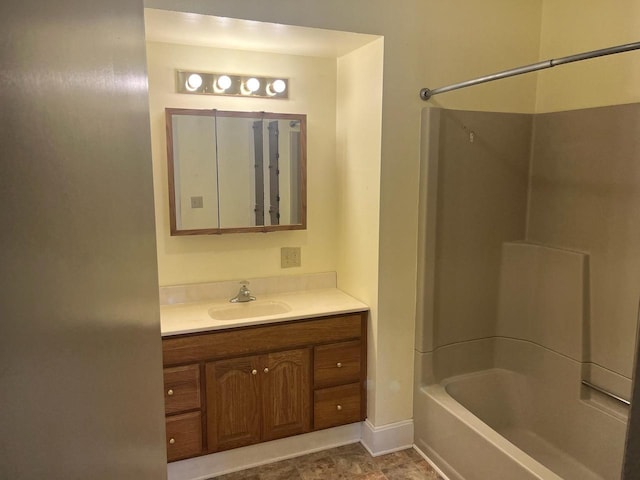 bathroom with vanity, baseboards, and shower / bath combination