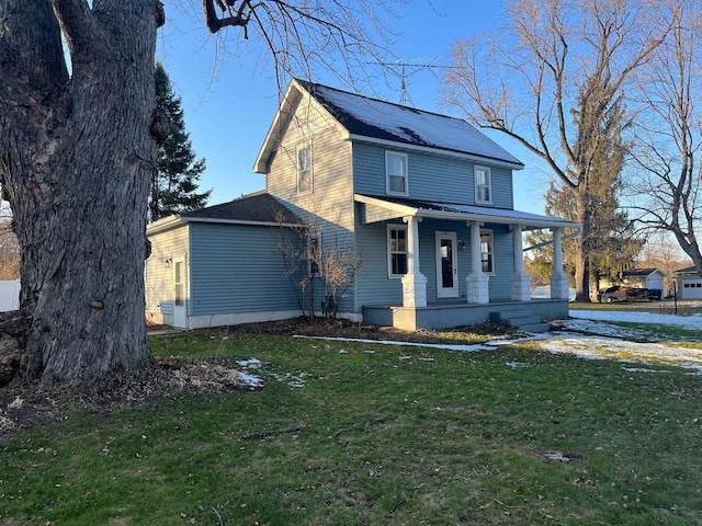 view of front of house with covered porch and a front lawn