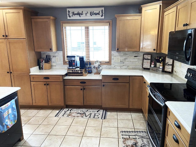 kitchen featuring tasteful backsplash, black appliances, and light countertops