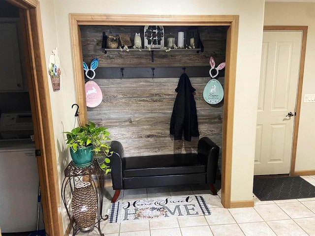 mudroom with tile patterned flooring, washer / dryer, and baseboards