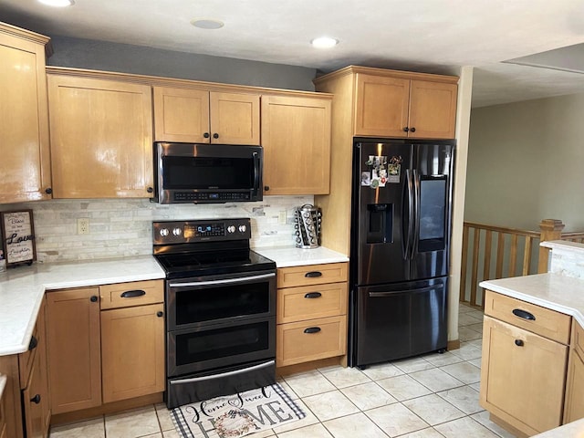 kitchen featuring light tile patterned floors, double oven range, light countertops, and black refrigerator with ice dispenser