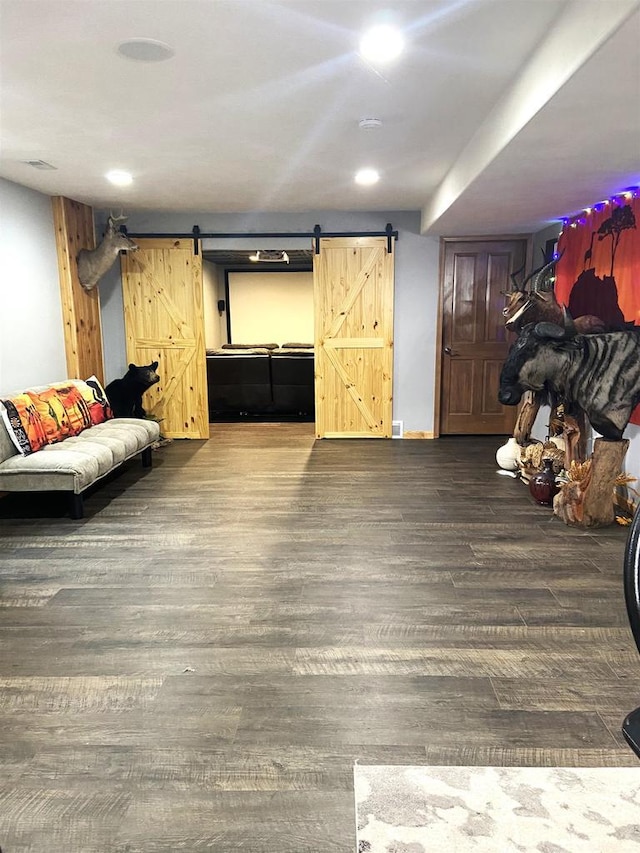 living area featuring recessed lighting, a barn door, and wood finished floors