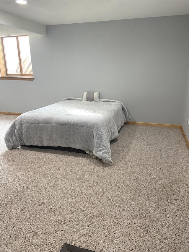 bedroom featuring baseboards and carpet