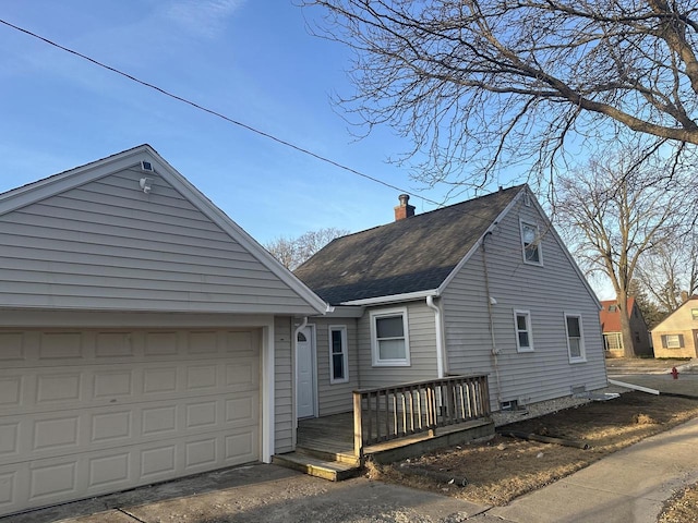 view of front of house with a wooden deck, driveway, roof with shingles, and a chimney