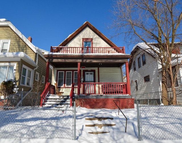 view of front of property featuring a fenced front yard, covered porch, and a gate