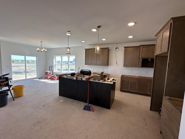 1721 Hammock Ln, Oconomowoc, WI 53066 - kitchen featuring a kitchen island, a chandelier, recessed lighting, light colored carpet, and pendant lighting