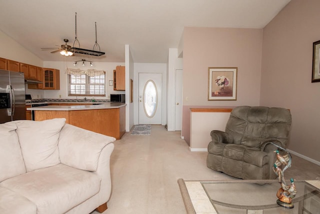 living area featuring baseboards and lofted ceiling