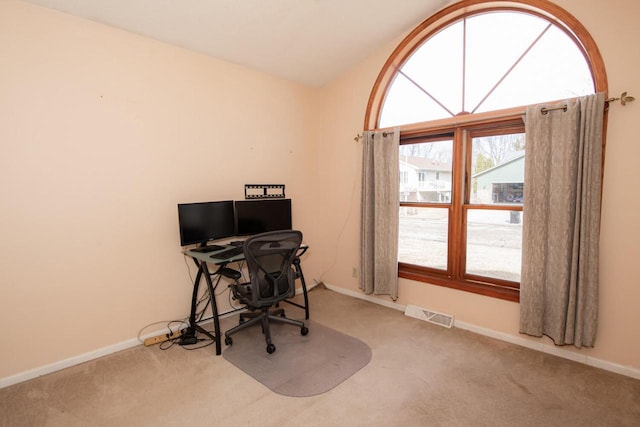 home office with visible vents, carpet floors, baseboards, and vaulted ceiling