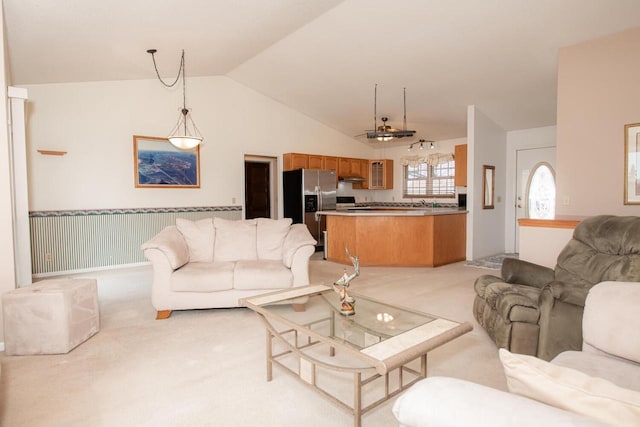 living area with vaulted ceiling and light carpet