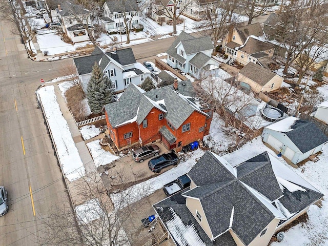 snowy aerial view featuring a residential view