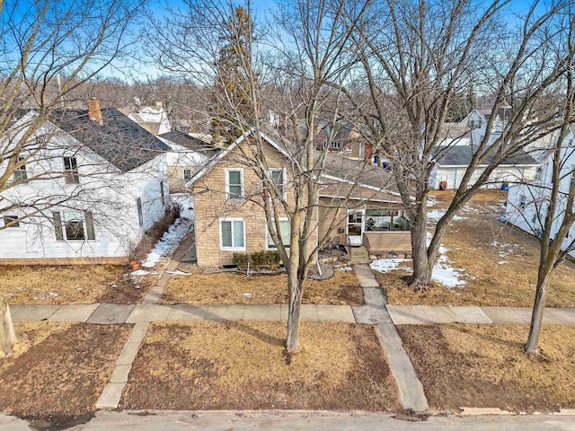 view of front of house featuring a residential view and brick siding