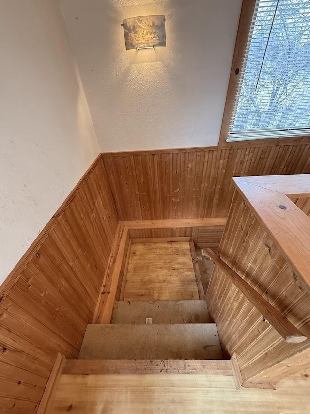 stairs with wooden walls and wainscoting