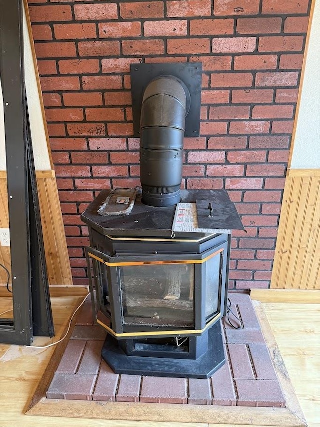 room details with wainscoting and a wood stove