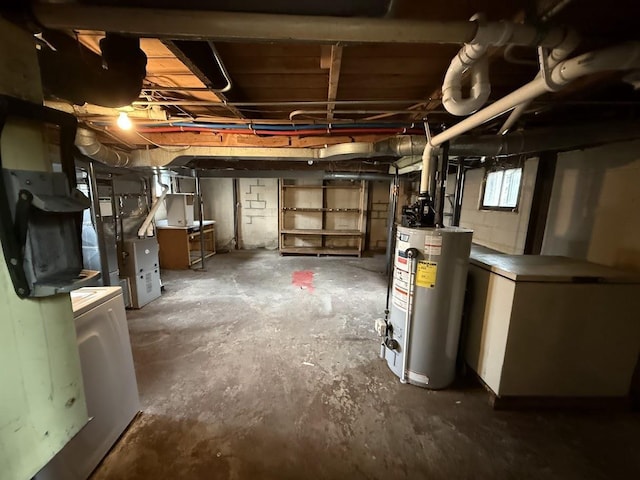 below grade area featuring washer / dryer, heating unit, gas water heater, and refrigerator