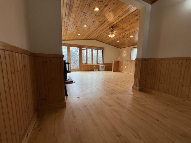 bonus room featuring a wainscoted wall, a ceiling fan, light wood-style floors, wooden ceiling, and vaulted ceiling