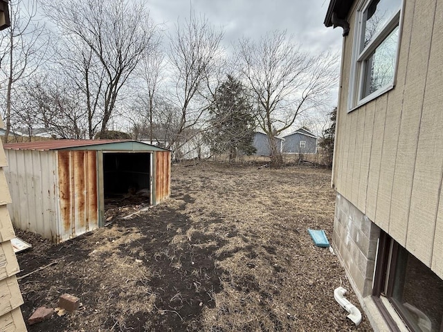 view of yard with an outbuilding and a shed