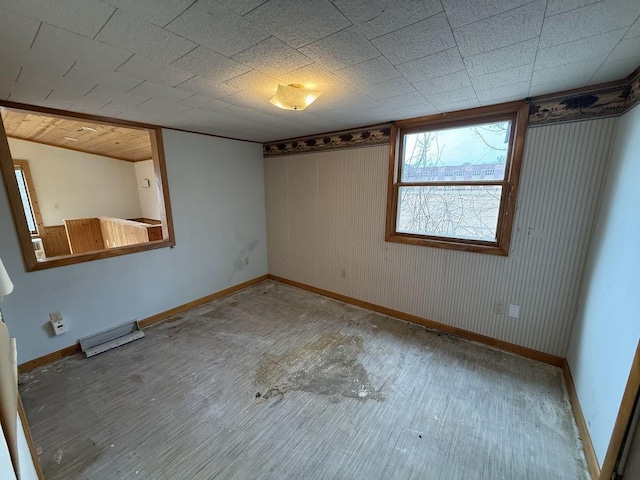 empty room with wood finished floors and baseboards